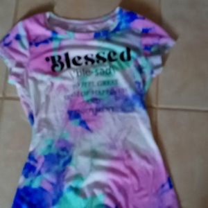 A tye dye t shirt with blessed meaning on it